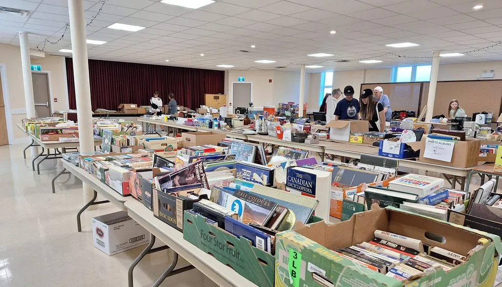 Shoppers browsing household goods at the Next to New Sale