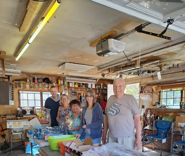 Volunteers in the workshop with dozens of packed lunches ready for delivery
