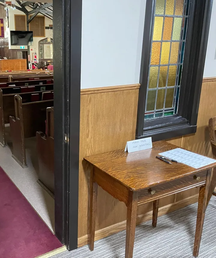 Looking into the sanctuary through the side door, past the welcome table