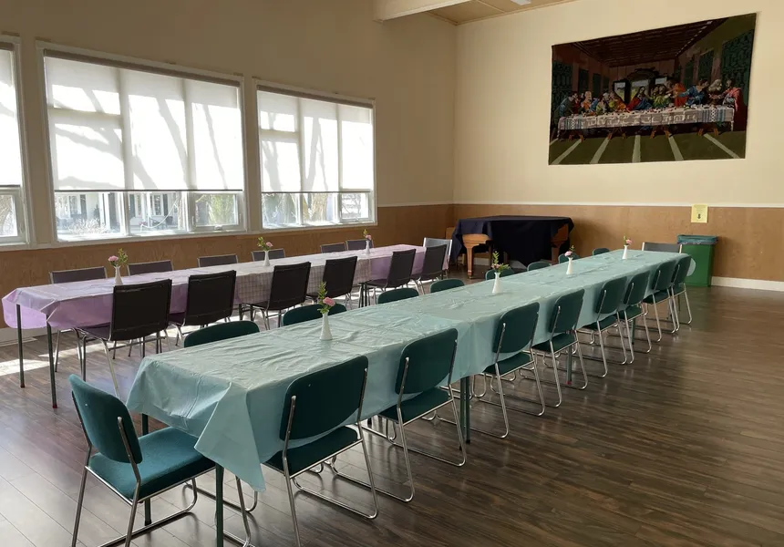 The Upper Hall arranged reception-style with long tables and green tablecloths under bright windows